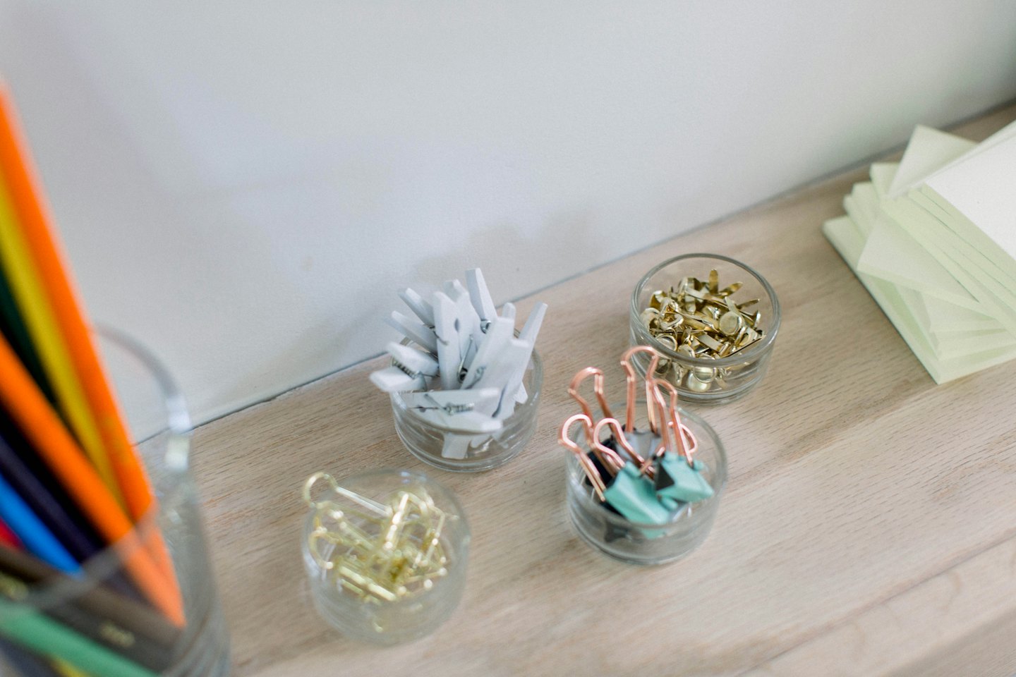 Office supplies organized neatly on a wooden desk.